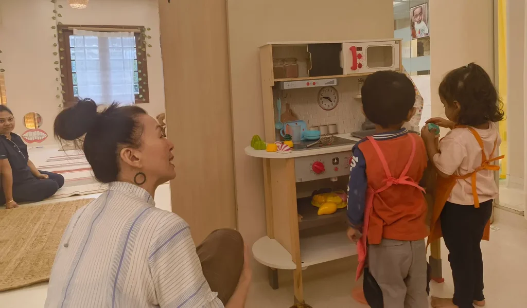 Facilitator and child engaged in learning activity