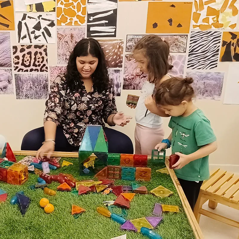 Reggio Emilia facilitator observing preschoolers during an investigation at Circles & Cycles, Bandra