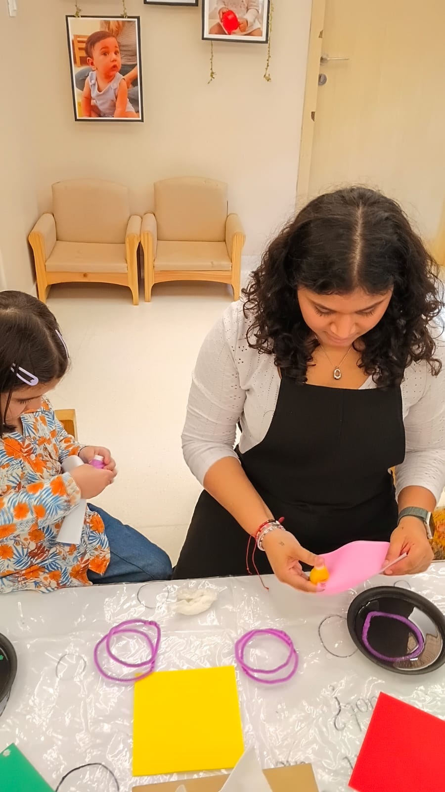 Educator tending to a child with a first-aid kit at Circles & Cycles, Bandra