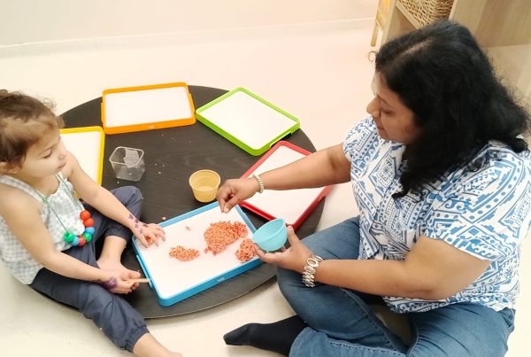 Facilitator attentively supervising young children at play at Circles & Cycles, Bandra