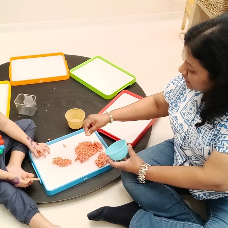 Facilitator attentively supervising young children at play at Circles & Cycles, Bandra