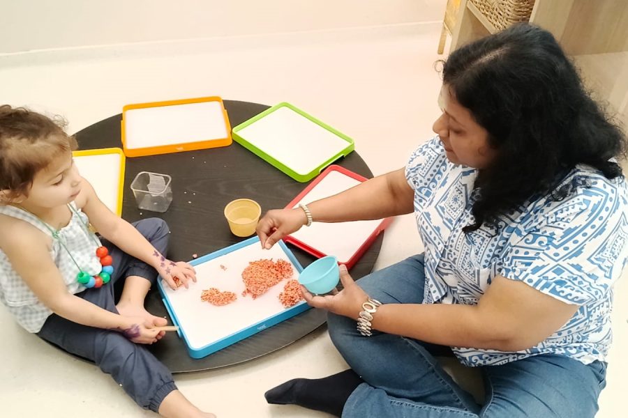 Facilitator attentively supervising young children at play at Circles & Cycles, Bandra