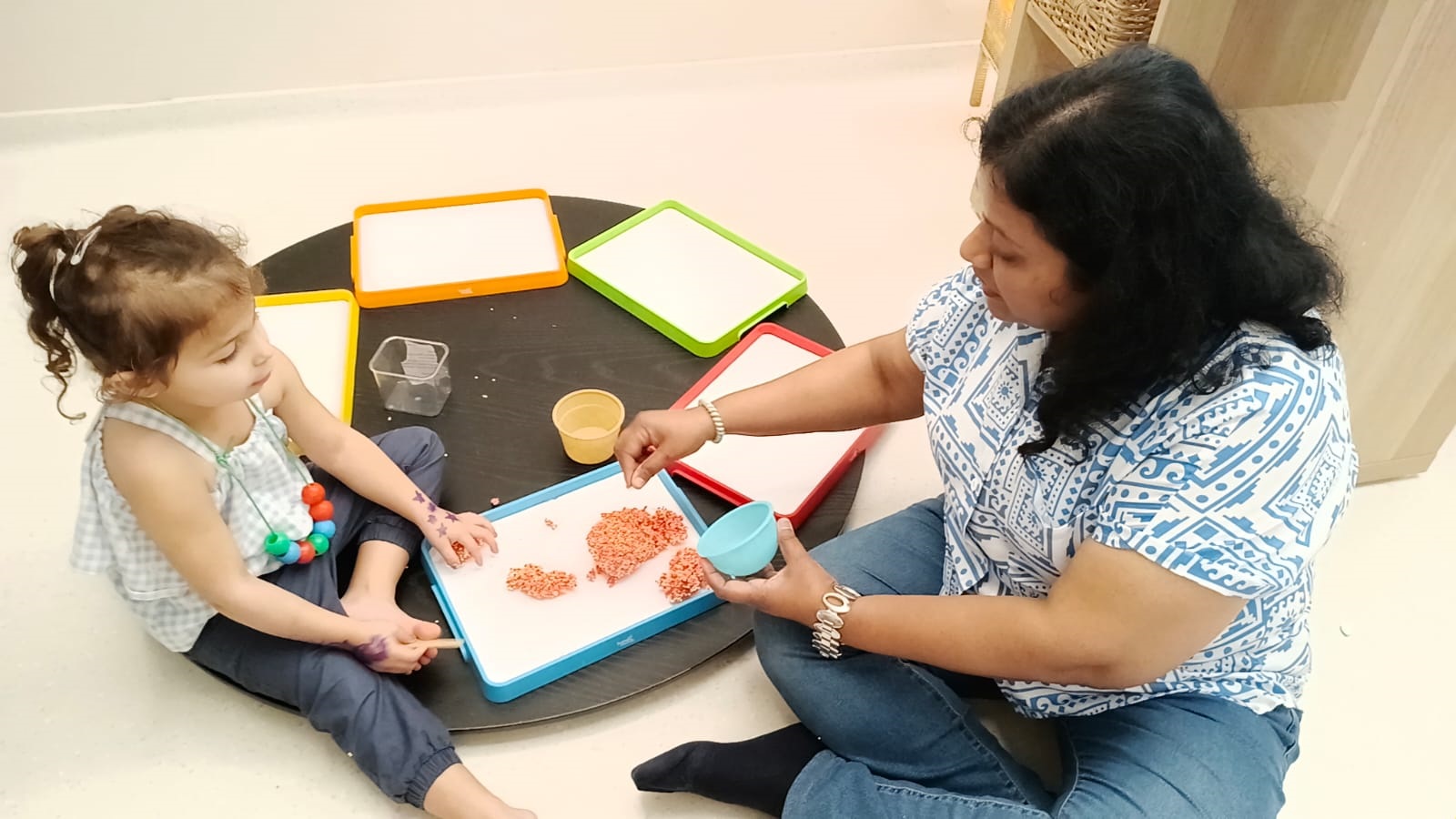Facilitator attentively supervising young children at play at Circles & Cycles, Bandra