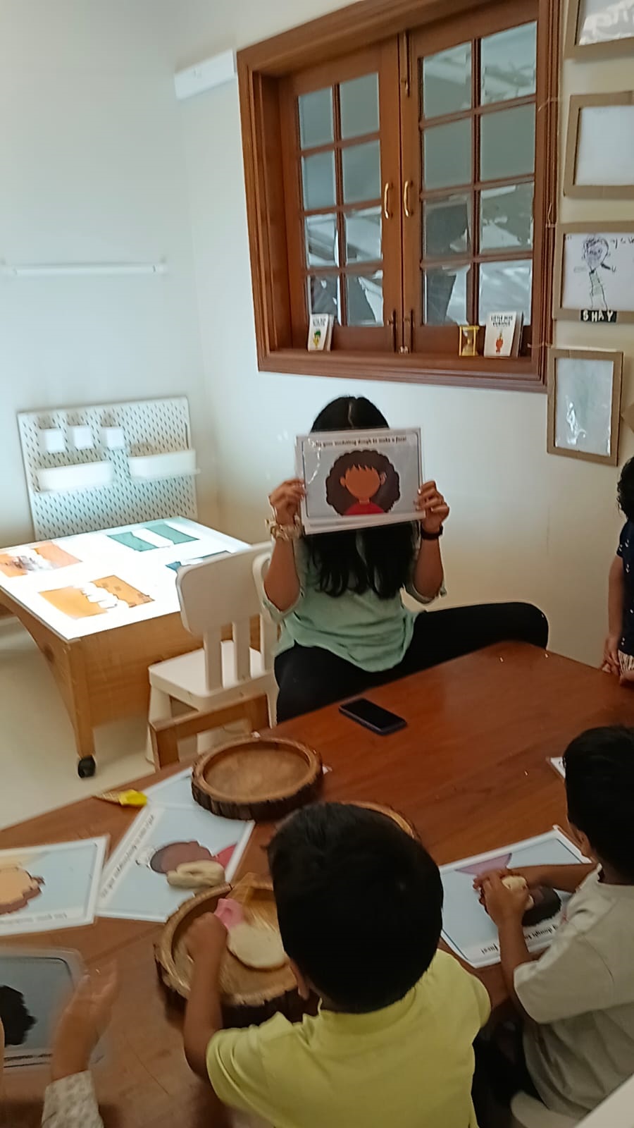 Children using books to name emotions with a facilitator at Circles & Cycles, Bandra