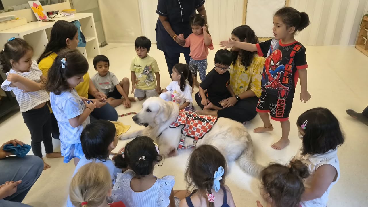 Child engaged in a classroom activity with adult support at Circles & Cycles, Bandra